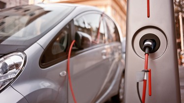 An electric car charging on the street