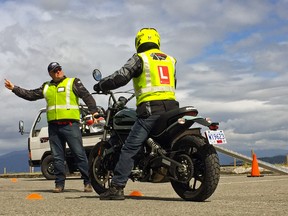 Desmond Rodenbour of High Gear Motorcycle Training gives tips to a client in Vancouver, B.C.