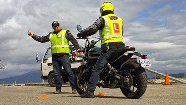 Desmond Rodenbour of High Gear Motorcycle Training gives tips to a client in Vancouver, B.C.