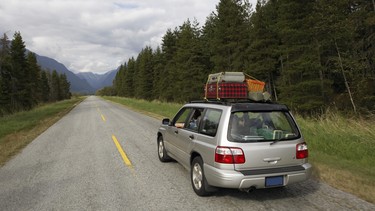 Sports utility vehicle driving on rural road.