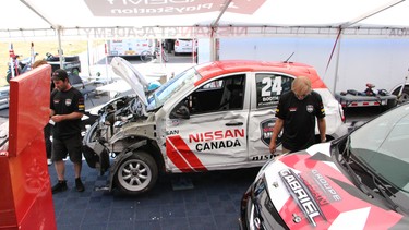 Crews work to fix David Booth's No. 24 Nissan Micra after a particularly nasty crash before this weekend's race.