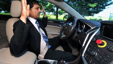 Raj Rajkumar, professor of engineering at Carnegie Mellon University, drives the autonomous vehicle down Schenley Drive in Schenley Park in Pittsburgh, on June 1, 2016. The university has been working on a self-driving vehicle for nearly three decades, but the effort kicked into high gear in February 2015 when Uber announced it would partner with CMU's National Robotics Engineering Center.