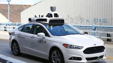 A self-driving Ford Fusion for Uber is test driven in Pittsburgh.