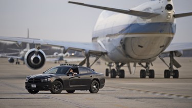 A military police officer sits in his car on the tarmac after Air Force One arrived, with US President Barack Obama aboard, on March 25, 2016 at Joint Base Andrews, Maryland. President Obama returned on the overnight flight from his trip to Cuba and Argentina.