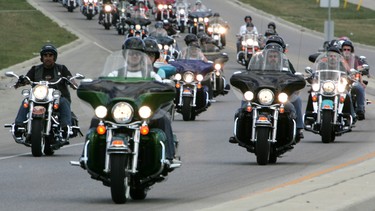 Hundreds of Harleys roar down Oxford Street as they parade through London, Ontario, as part of the HOGS - Harley-Davidson Owners Group annual rally