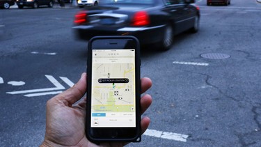 This file photo taken on March 25, 2015 shows an UBER application shown as cars drive by in Washington, DC. The US ride-sharing service Uber announced August 18, 2016 it had acquired the commercial transport-focused tech startup Otto as the company presses ahead with its pursuit of self-driving technology. The announcement came as the company also announced a $300 million effort with the Sweden-based automaker Volvo Cars to develop driverless cars."If that sounds like a big deal -- well, it is," Uber CEO Travis Kalanick said in a statement.