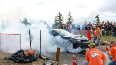 A car does a burnout at the First Alliance Church Show and Shine.