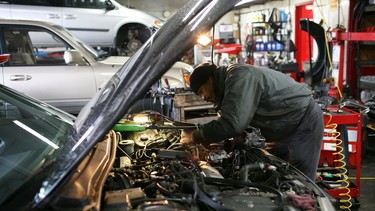 In this file photo, mechanic Antonio Ramos works on a car at San Rafael Firestone January 5, 2009 in San Rafael, California.