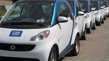 Car2Go's are lined up in Calgary's downtown streets.