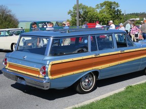 While early station wagons had real wooden bodies, later ones paid homage to the tradition with trim pieces, as on this 1965 Ford Falcon Country Squire. It was priced at US$14,750.