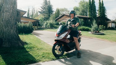 Ron McLean proudly astride his 2015 Honda PCX 150 at the bottom of his family home driveway.