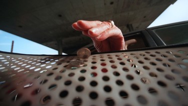 A commuter drops 50 cents toll in a bin on the Lee Roy Selmon Expressway in Tampa, Florida.