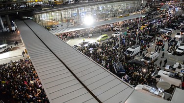 Protestors rally during a demonstration against the new immigration ban issued by President Donald Trump at John F. Kennedy International Airport on January 28, 2017 in New York City.