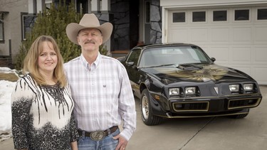 Lisa and Cliff Zimmer stand near her 1979 Pontiac Trans Am outside their home in Calgary, Alta., on Tuesday, Feb. 14, 2017. They recently finished restoring the car and will have it in the upcoming World of Wheels.