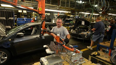 A Ford employee building compact cars at the company's Michigan assembly plant.