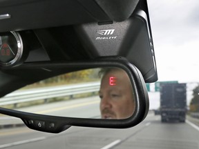 A Mobileye camera system that can be installed in your car to monitor speed limits and warn drivers of potential collisions, mounted behind the rearview mirror.