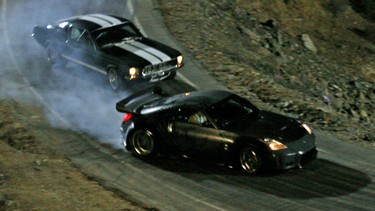Underdog street racer Sean Boswell (Lucas Black in a '67 Ford Mustang) and Boswell's drifting rival D.K., the "Drift King" (Brian Tee in an '02 Nissan Fairlady 350Z) jockey for position in The Fast and The Furious: Tokyo Drift.