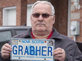 Lorne Grabher displays his personalized licence plate in Dartmouth, N.S. The controversy over Lorne Grabher's licence plate, which reads "GRABHER", could be settled in court after the Nova Scotia government refused a request from a group of lawyers to allow Grabher to resume using the now-banned plate.