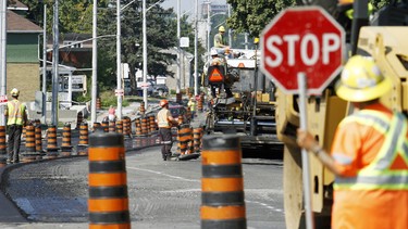 Road workers repaving a stretch of road in Belleville.