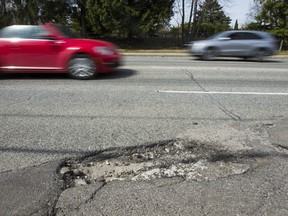 A typical Toronto street, where dodging potholes is almost a sport.