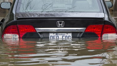 A flooded car is seen on Ile Bizard, Que., near Montreal, Monday, May 8, 2017