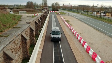 A Renault Kangoo Z.E. electric car testing an inductive charging road near Paris.