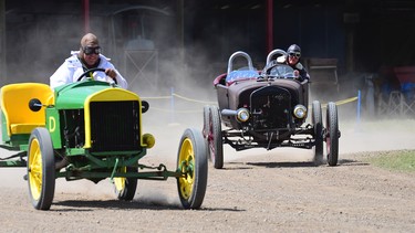 A couple of Model T racers kick up some dirt.