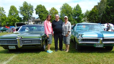 Byron Carr flanked by daughters Lisa and Deb and his two rare Canadian-built Pontiac two-hardtops.