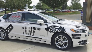 This Aug. 24, photo shows the specially designed delivery car that Ford Motor Co. and Dominoís Pizza will use to test self-driving pizza deliveries, at Dominoís headquarters in Ann Arbor, Mich. Ford and Dominoís are teaming up to test how consumers react if a driverless car delivers their pizzas. The car, which can drive itself but will have a backup driver, lets customers tap in a code and retrieve their pizza from a warming space in the back seat.