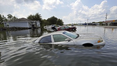 Flooded cars sit alongside a roadway in the aftermath of Tropical Storm Harvey, in Port Arthur, Texas.