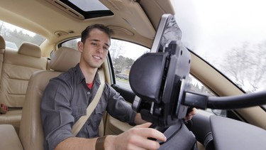 In this file photo, Ben Gleitzman uses traffic and navigation app Waze as he drives to work in Menlo Park, Calif.