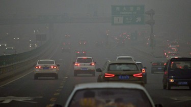 Commuters drive on a road in heavy pollution in Beijing.
