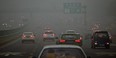 Commuters drive on a road in heavy pollution in Beijing.