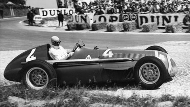 In this July 1, 1951 photo Juan Manuel Fangio comes out of a bend at speed during the race, driving a supercharged 1.5 Liter Alfa Romeo during the Grand Prix D'Europe at Rheims, France.