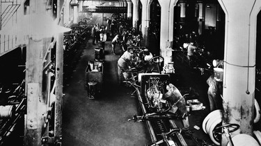 Workers assemble the Model T in 1914 at Ford's Highland Park plant in Michigan.