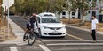 A Chrysler Pacifica minivan equipped with Waymo's self-driving car technology, being tested with the company's employees as a biker and a pedestrian at Waymo's facility in Atwater, Calif.