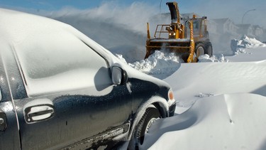 City Of Calgary crews work to clear the road on Saddlecreek Drive after a snowstorm.