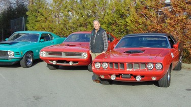 Vancouver car dealer Wayne Darby with his lineup of muscle cars heading for the Barrett-Jackson Auction: 1970 Mustang Boss 429, 1970 Hemi Cuda and 1971 Hemi Cuda convertible re-creation.