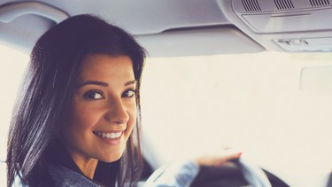 Smiling woman sitting in a car