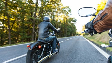 Man seat on the motorcycle on the forest road