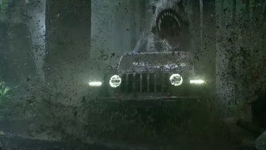 A digital Tyrannosaurus Rex chases down a 2019 Jeep Wrangler in a Super Bowl 52 advertisement.