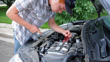 Homegrown handyman Ian Geldof tinkers with the battery of his car.