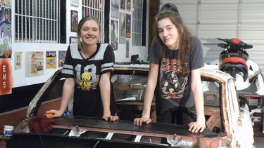 Sarah Wilkinson and Jasmine Sweet celebrate the disassembly of the 1961 Pontiac during a complete restoration.