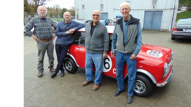 Jim Brown, Randy Schultz and Peter Trant with the Austin Cooper they restored in four months as a gift for car painter Peter Taylor (second from right).