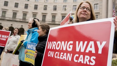 Protesters with Environment America stand outside the Environmental Protection Agency as Environmental Protection Agency Administrator Scott Pruitt holds a news conference on his decision to scrap Obama administration fuel standards, in Washington, Tuesday, April 3, 2018.