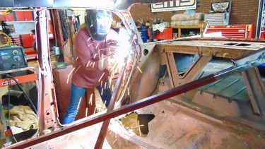 Sarah Wilkinson arc welding the body of her 1961 Pontiac