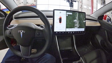 The dashboard interior of the semi-autonomous 2018 Tesla Model 3 Tuesday, April, 2018, at the Consumer Reports Auto Test Track in Colchester, Conn.
