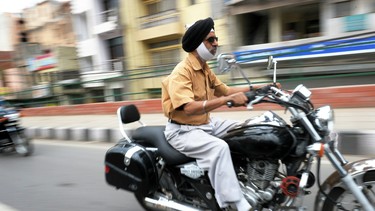 Sikh man wearing turban riding on motorcycle