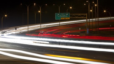 Cars and truck cross the Quesnell Bridge along Whitemud Drive in Edmonton, Alta.