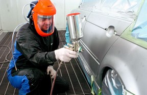 Vahan Kazazian paints a car at Burwell Auto Body Ltd. in London, Ontario.